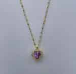 a gold necklace with a purple heart pendant